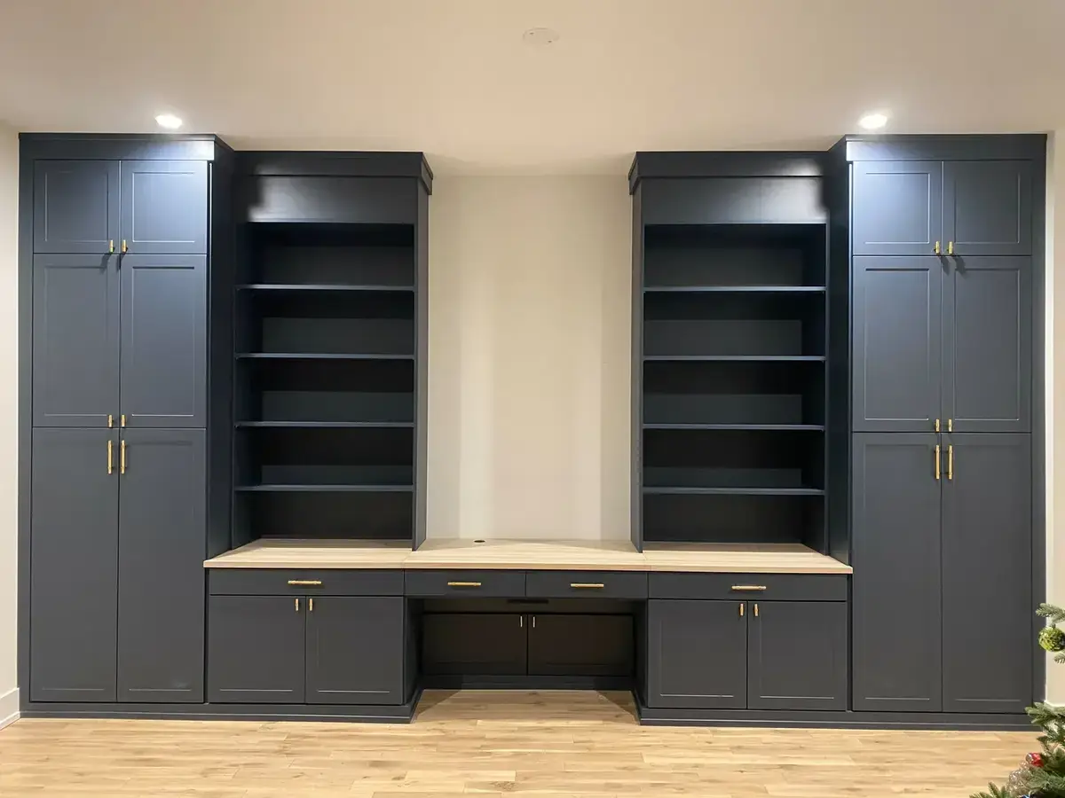 Same navy built-in wall unit fresh from installation — clean lines before styling